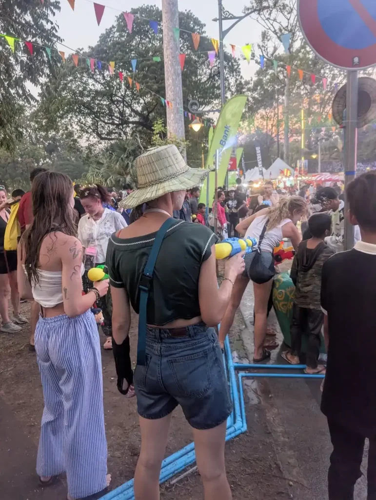Two Western tourists with water guns participating in the Songkran festival. A continual water fight and splashing of water is part of this festival.