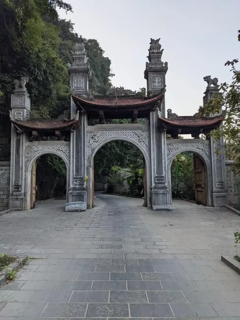 An entry way on a rural country road in Vietnam in the Chinese style fashion. It is made up of three arches, each of which a motorbike can ride through. The middle arch is the main entry way, which can fit a small car. It seems to be for asthetics, or possibly for feng shui (meaning "wind water") spiritual purposes.