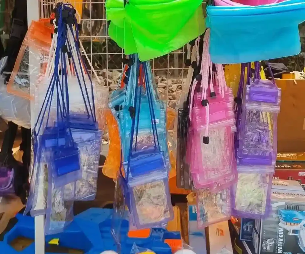 A plastic pouch that is used to protect phones & other stuff inside from water. The pouches in the image are not fully waterproof. They have a flap that cover the opening. These are quite cheap in price. They are often sold during the Songkran holiday and word well enough for the most part. Songkran holiday is a holiday in Cambodia, Laos, and Thailand which involves splashing each other with water. Essentially, it is one massive water fight, and everyone gets soaking wet.