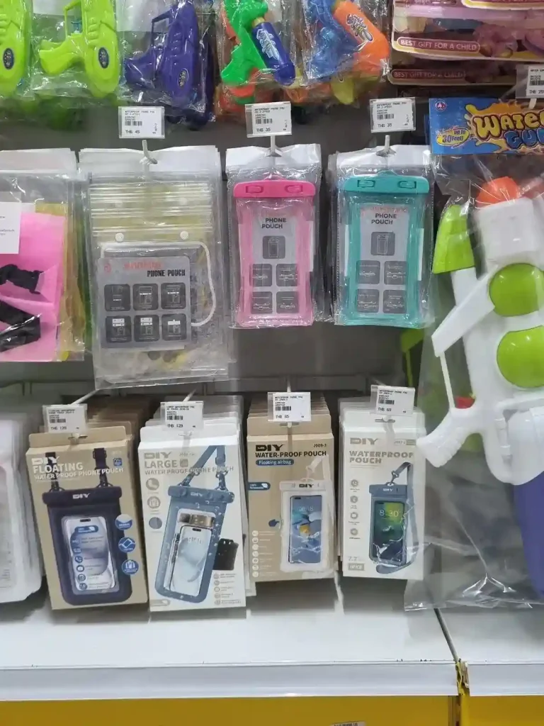 Several options for waterproof phone pouches at a Mr. DIY store in Thailand. The pouches on display show that they come with a lanyard attached. A waterpoof pouch is used to protect a phone & any other valuables you put inside of it. The pouches are made of waterproof material. The opening of the pouches have a plastic clamping mechanism to seal it shut, and keep it air/water-tight. This also prevent typical dirt and debri getting inside the pouch. The pouches are flat, and are big enough in size to fit a larg-sized smart phone.